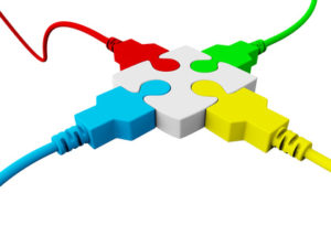 Cables of different colors are connected together at a single puzzle piece